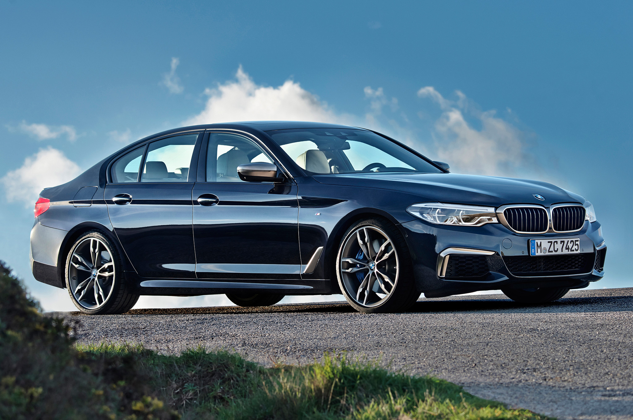 2018-BMW-M550i-xDrive-front-side-view-on-hill.jpg