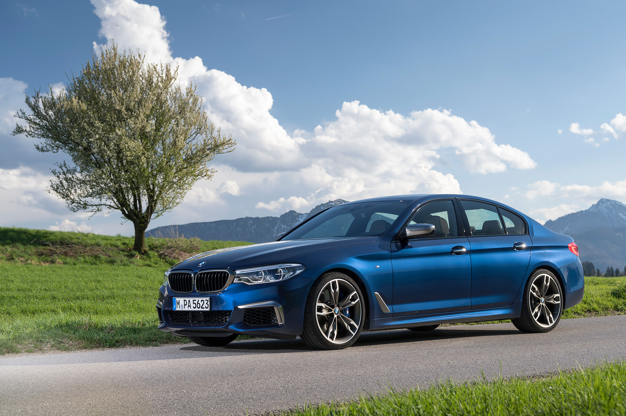 2018-BMW-M550i-xDrive-front-side-view-with-tree.jpg