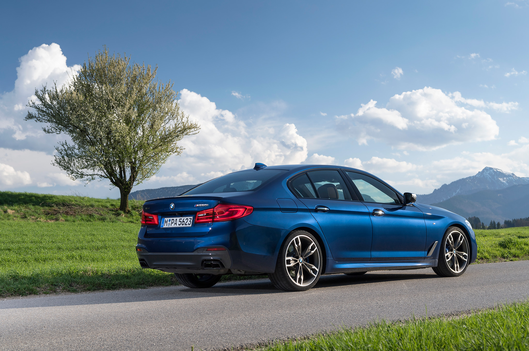 2018-BMW-M550i-xDrive-rear-side-view-with-tree.jpg